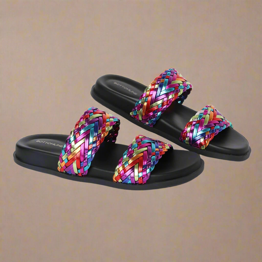Colorful woven sandals with black soles on a white background